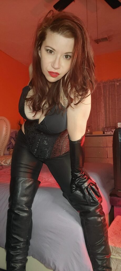 Mistress Sarah Blake, femdom keyholder, in black gloves and boots